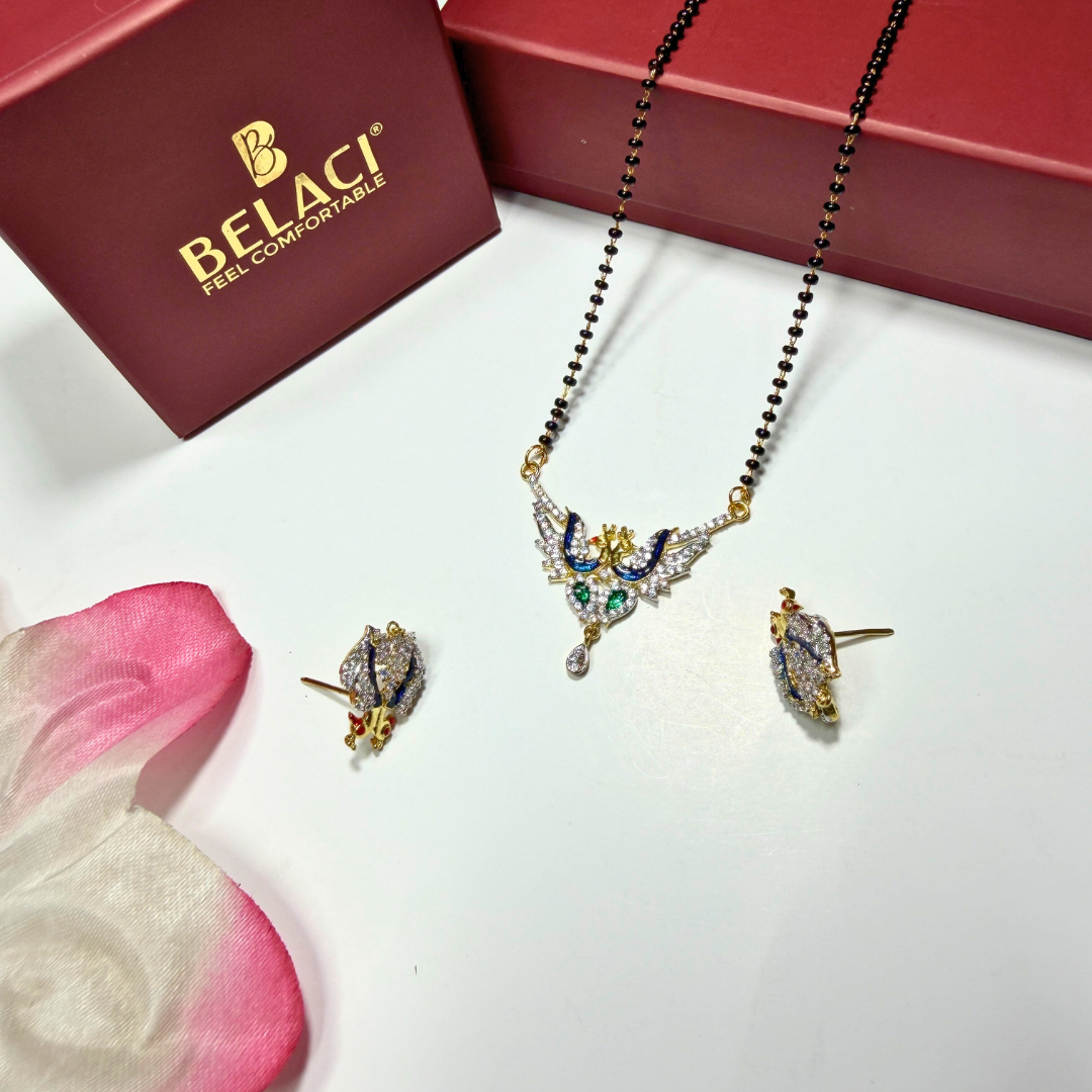 AD Mangalsutra Jewelry set with necklace and earrings on a white surface with a BELACI box in the background.