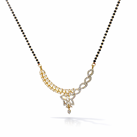 AD Mangalsutra with gold and black beads on a white background