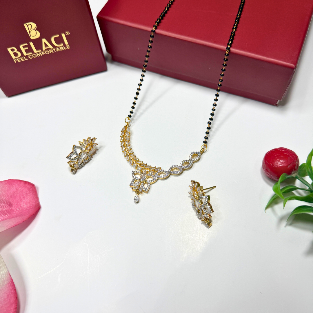 AD Mangalsutra Jewelry set with necklace, earrings, and ring on a white surface with a BELACI box in the background.