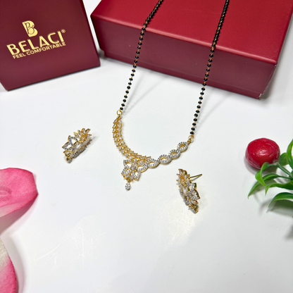 AD Mangalsutra Jewelry set with necklace, earrings, and ring on a white surface with a BELACI box in the background.