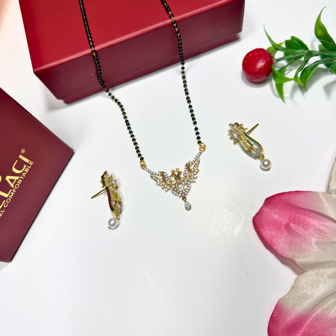 AD Mangalsutra Jewelry set with necklace and earrings on a white surface with a red box and pink flower petal.