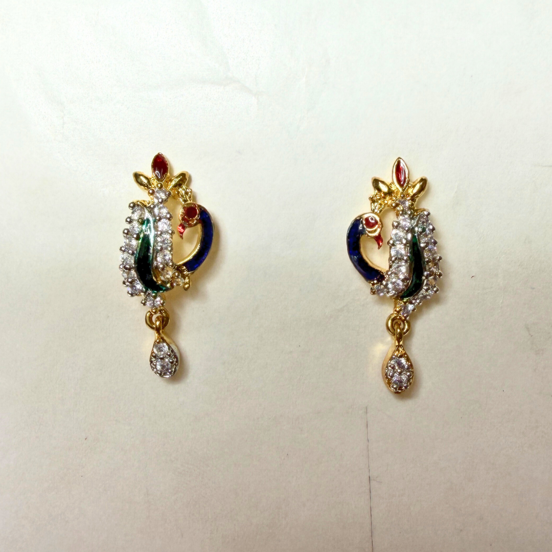 Pair of ornate AD earrings with gemstones on a light background