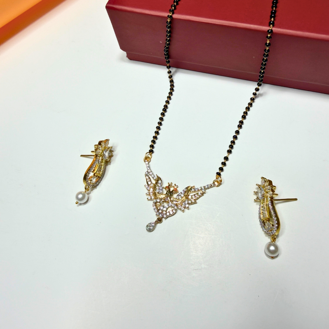 Gold AD Mangalsutra and earrings with black beads on a white surface