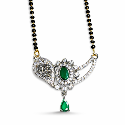 Designer AD Mangalsutra with green gemstone and black beads on a white background
