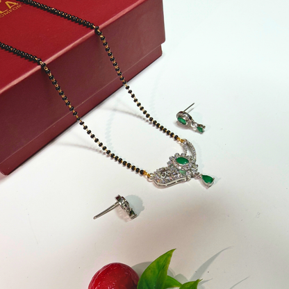 Mangalsutra set with necklace and earrings on a white surface with a red box in the background.