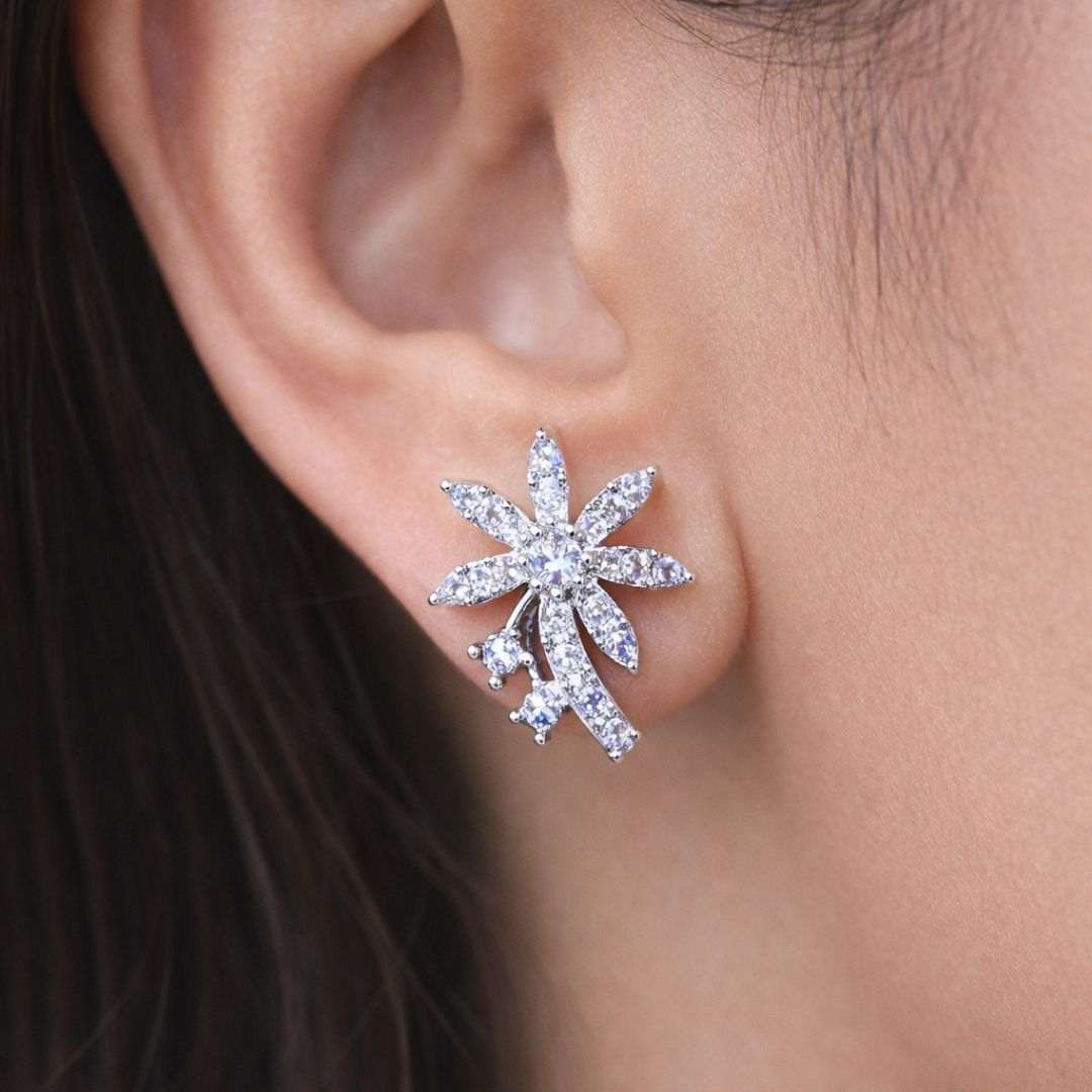 Close-up of a person wearing a silver star-shaped earring.