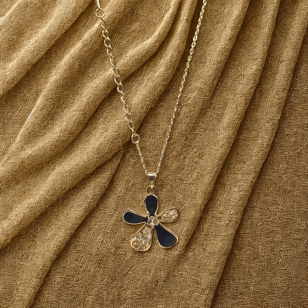 Necklace with a blue and gold pendant on a brown fabric background