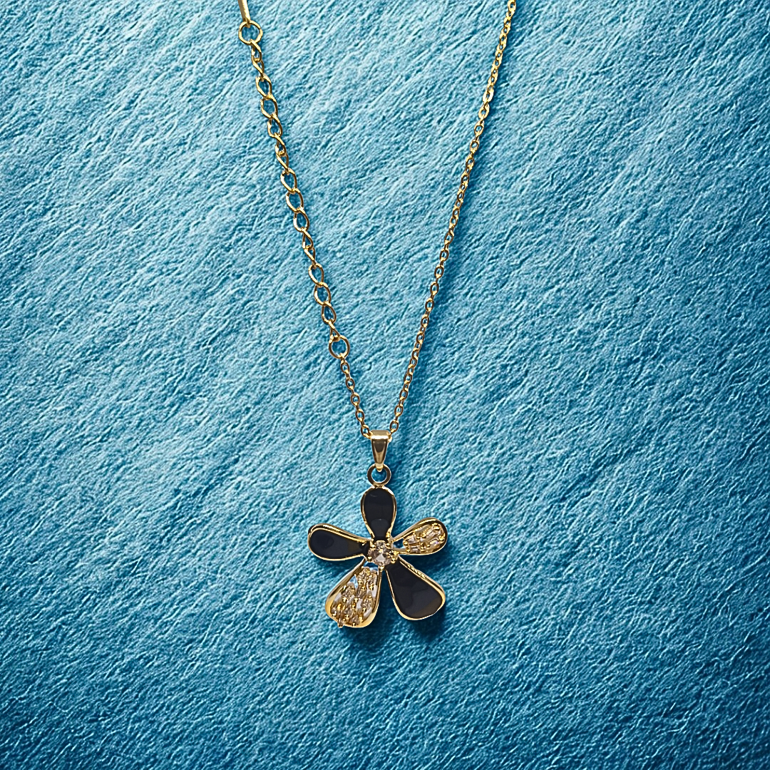 Flower-shaped pendant necklace on a blue textured background