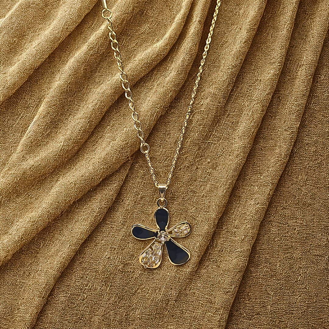 Necklace with a blue and gold pendant on a brown fabric background
