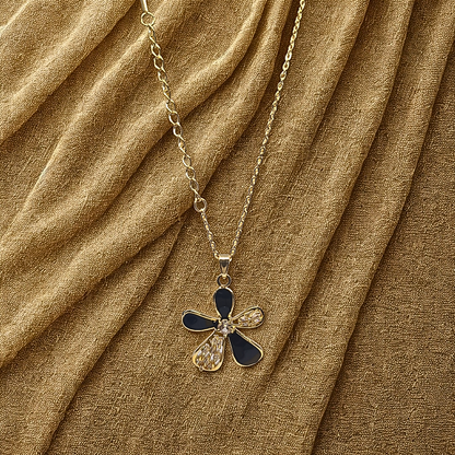 Necklace with a blue and gold pendant on a brown fabric background