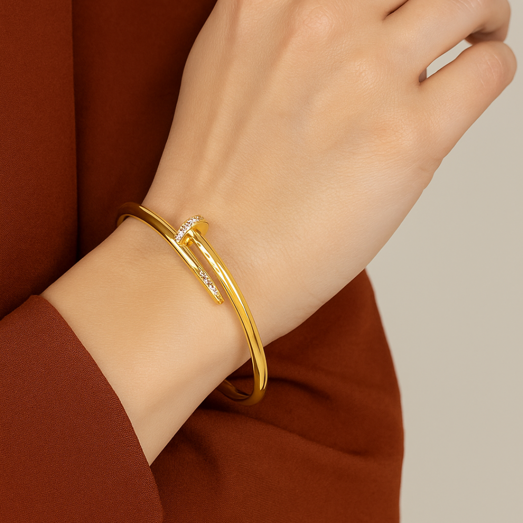 Gold Bracelet for Women on a wrist with a neutral background