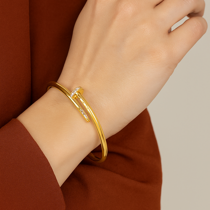Gold Bracelet for Women on a wrist with a neutral background